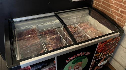 a display case with many different types of food at JEPPESEN RESIDENCE in Almaty
