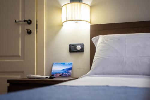a bedroom with a bed with a laptop on a table at Casa Rosaria Amalfi Coast in Vietri sul Mare