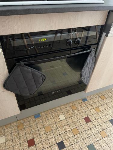 a stove in a kitchen with its door open at Pandrignes, appartement F2 in Pandrignes
