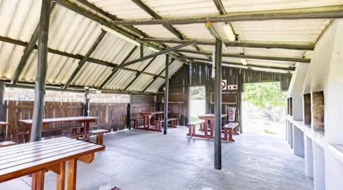 a room with benches and tables in a building at South Coast Riviera 203 in Port Shepstone