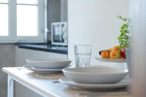 a kitchen counter with two bowls and a plate of fruit at Apartamentos Turísticos El Puerto de Comillas in Comillas