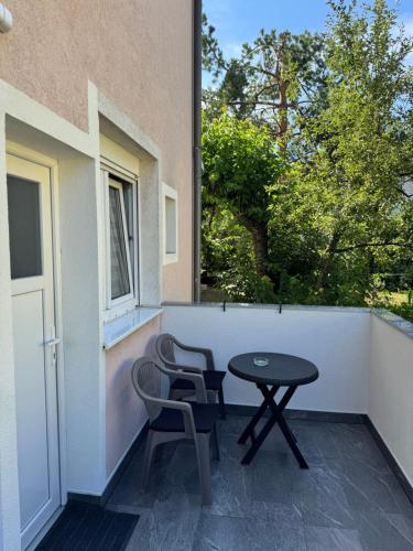 a patio with a table and two chairs on a balcony at Miki in Sarajevo