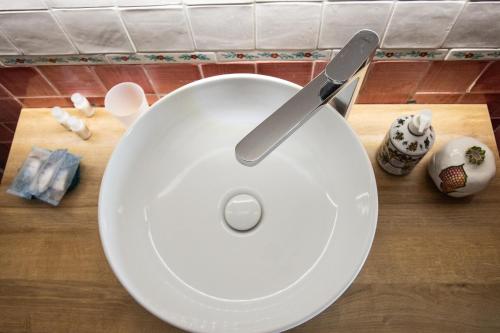 a white plate with a knife on top of a counter at Casa Rosaria Amalfi Coast in Vietri sul Mare