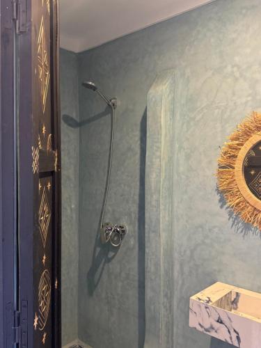 a shower stall in a bathroom with a mirror at Ecolodge Dar bouhouta in Tahannout