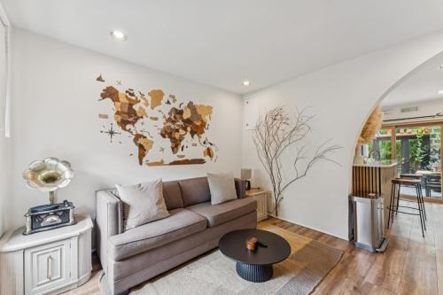 a living room with a couch and a map on the wall at Entire rowhouse in Capitol Hill with free parking in Washington, D.C.