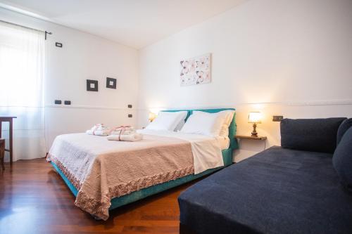 a bedroom with a bed and a couch at Casa Rosaria Amalfi Coast in Vietri sul Mare