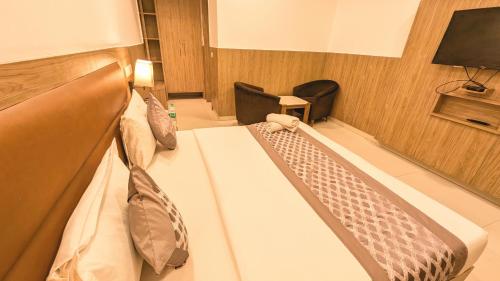 a room with a bed with ties on it at AIRPORT HOTEL ELEVATE NEAR Delhi Airport WITH- Free Airport PICKUP in New Delhi