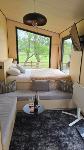 a room with a couch and a bed and a table at RE Plai in Zărneşti