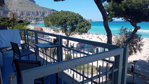 a balcony with a view of a beach at Rocca Mondello Rooms, Beach and Sea in Palermo