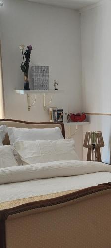 a bedroom with a bed with a vase of flowers on the wall at L'Écrin Appart in Villedieu-les-Poëles