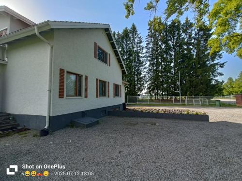 a white house with a driveway in front of it at Nina`s GuestHouse, Jämsä City, 160 m2, Include x2 Himos Ski Pass in Jämsä