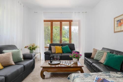 a living room with two couches and a coffee table at Villa Fiorenzani in Radicondoli