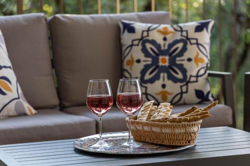 two glasses of wine and a basket on a table at Villa Fiorenzani in Radicondoli
