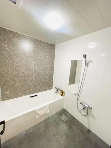 a bathroom with a shower and a sink at Hotel Arashi Shinsaibashi No001 in Osaka