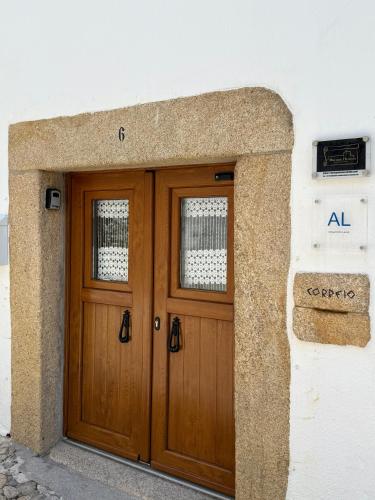 a pair of wooden doors on a building at Maruan Heaven in Marvão