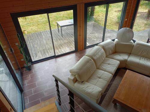 a living room with a couch and a table at Gîte de la Croix Regnault in Raids