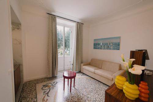 a living room with a couch and a table at Dimore di Mare in Arenzano