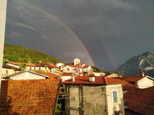 a rainbow over a city with houses and roofs at BnB Tana del Gufo in Abbadia Lariana