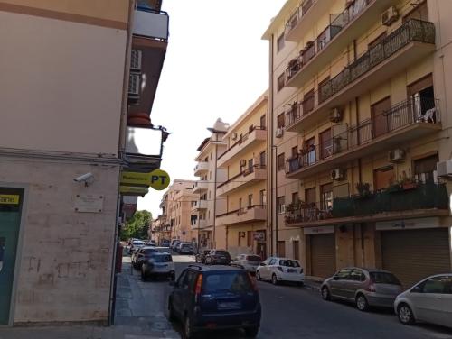 a city street with cars parked on the street at Monolocale Libertà in Reggio Calabria