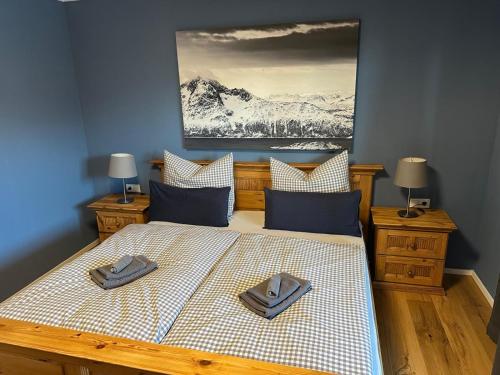 a bedroom with a bed with two slippers on it at REIT IM WINKL - ValleyViewInn in Reit im Winkl