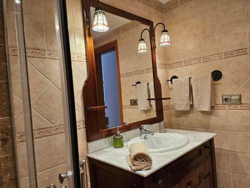 a bathroom with a sink and a shower and a mirror at Casa Anna in Costa Calma