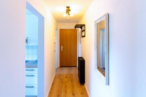 a hallway with a door and a mirror at Apartment Maro - nahe Basel in Grenzach-Wyhlen