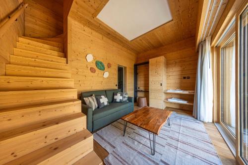 a living room with a green couch and a table at MAD Retreat Hotel in Nendaz