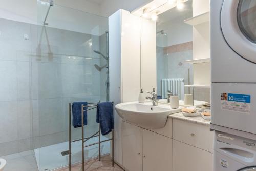a white bathroom with a sink and a shower at FREE PARKING-HISTORICAL LUXURY PALACE- CITY VIEW-Free Wifi&Pet Friendly in Trento
