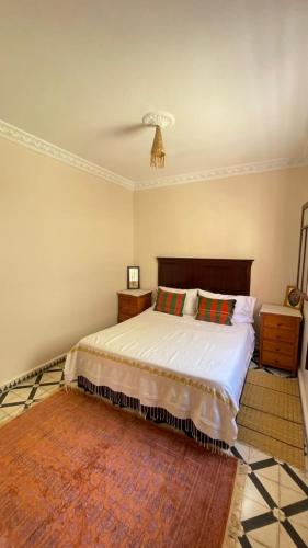 a bedroom with a bed and a ceiling fan at mehek in Asilah