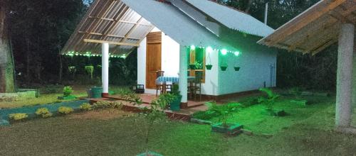 a model of a house in a garden at night at Little Haven Cottage in Sigiriya