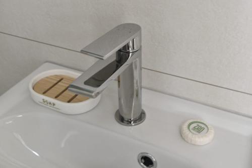 a bathroom sink with a faucet on top of it at Zen Cottage - Centre ville in Brest