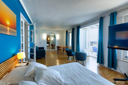a bedroom with a bed and a living room at Le Gîte de la Plage in Étretat