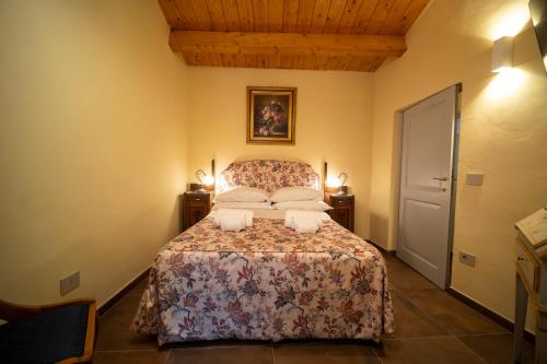 a bedroom with a bed with two pillows at Domus Hispellum in Spello