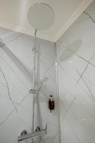 a shower head in a bathroom with a white ceiling at Sundaze in Fenais da Luz