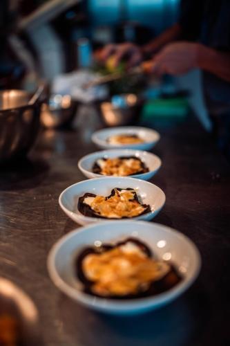 a row of plates of food on a table at MAD Retreat Hotel in Nendaz