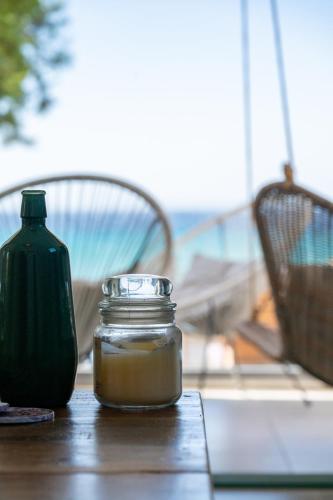 a jar of soy sauce sitting on a wooden table at Notte di Mare in Kardiani