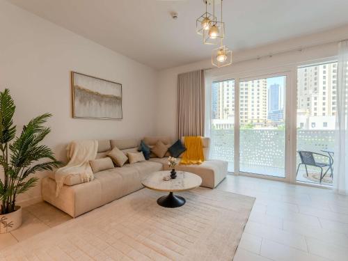 a living room with a couch and a table at Jumeirah Beach Residences Private Beach & Sea View in Dubai