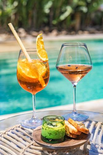 two glasses of wine and some food on a table at Villa Beldi in Essaouira