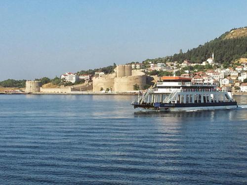 a large boat on the water near a city at Sera Palas Pansiyon in Canakkale
