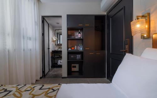 a bedroom with a bed with a black headboard at Iconic Hotel in Tel Aviv