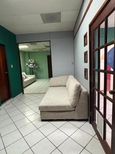a living room with a couch in a room at Hostel of Santurce in San Juan