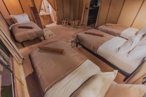 an overhead view of a room with three beds at Sultan's Sinbad Luxury Camp in Merzouga