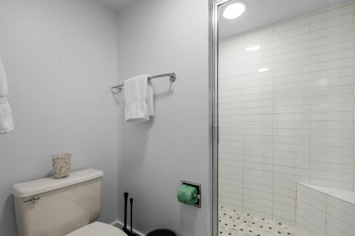 a white bathroom with a toilet and a shower at Just Beachy By Beachside Management in Siesta Key