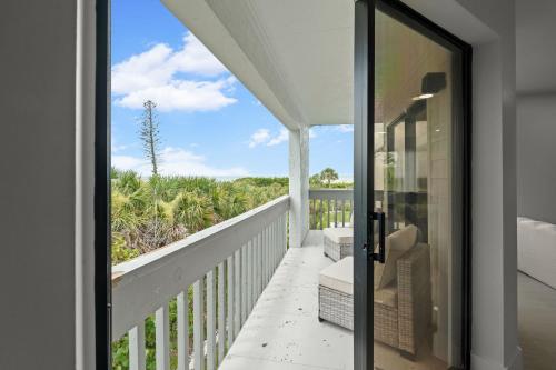 a balcony with a view of the ocean from a house at Just Beachy By Beachside Management in Siesta Key