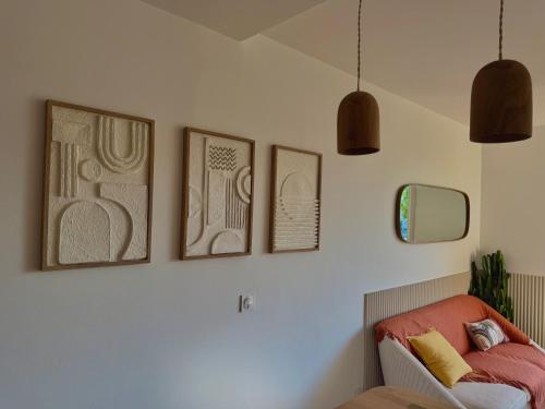 a room with three pictures on the wall and a bed at Appartement de Standing vue port in La Baule