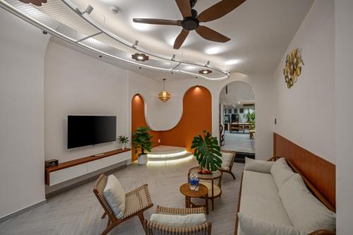 a living room with a couch and a flat screen tv at Shore House - Near My Khe Beach & City Centre by The Key in Da Nang
