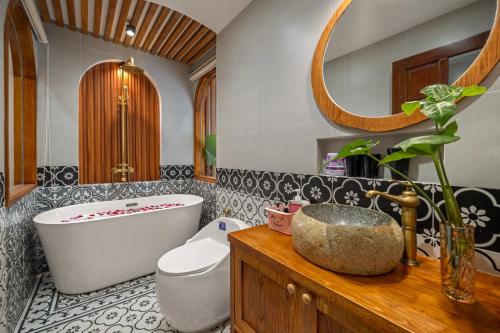a bathroom with a tub and a toilet and a sink at Shore House - Near My Khe Beach & City Centre by The Key in Da Nang