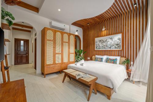 a bedroom with a large white bed and a table at Shore House - Near My Khe Beach & City Centre by The Key in Da Nang