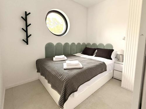 a bedroom with a bed with a mirror on the wall at CASA DEL MAR Apartamenty przy plaży in Pobierowo
