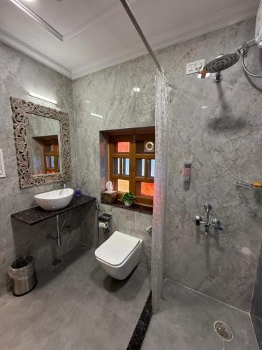 a bathroom with a toilet and a sink and a shower at The Sunrise Retreat in Jodhpur
